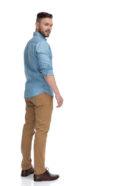 istock casual man standing and looking back over shoulder cool 1178037862