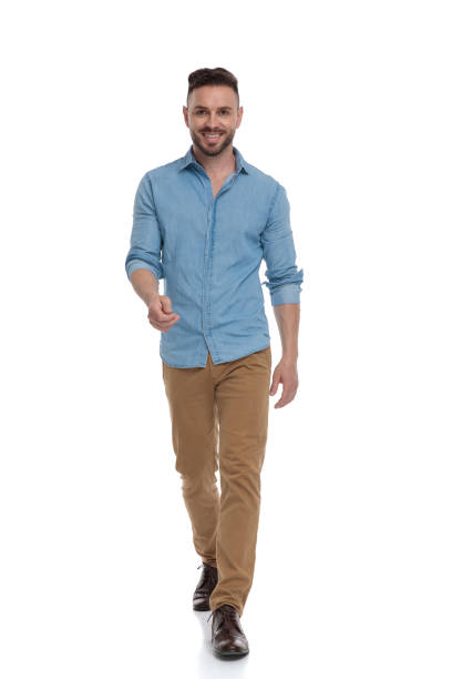 istock casual man walking with hand raised happy 1178037891