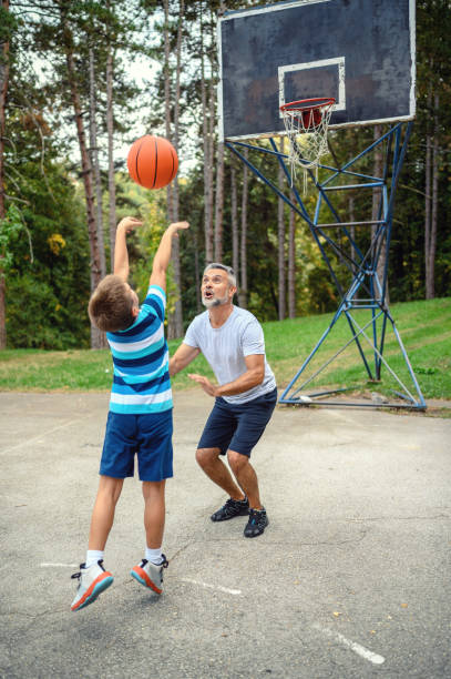 istock Father and son playing basketball 1178037944