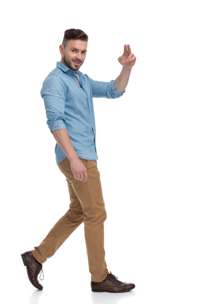 istock casual man walking and looking at camera with peace sign 1178038313