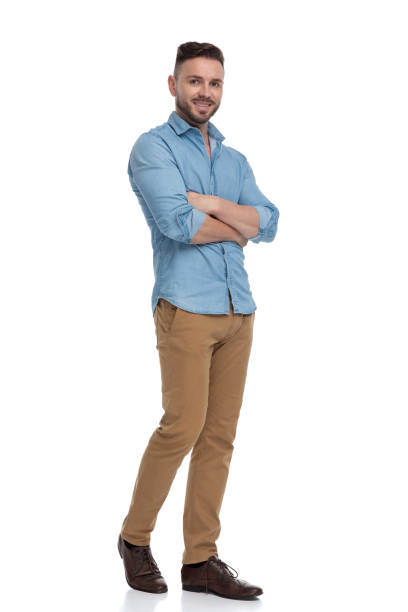 istock casual man walking with hands crossed happy 1178038456