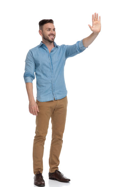 istock casual man standing and waving his hand happy 1178038571