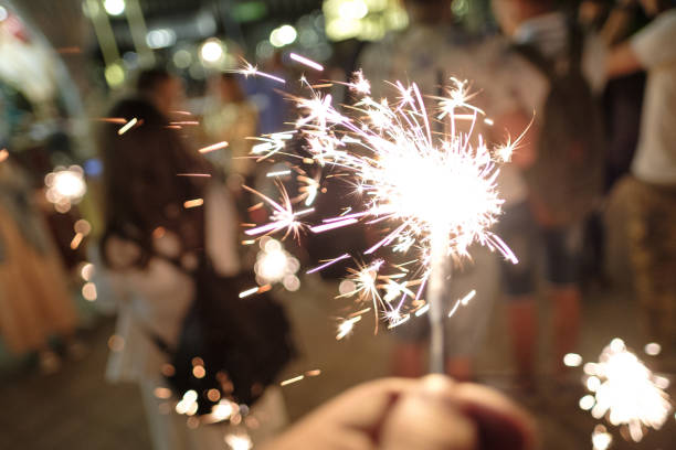 istock Hand with Sparkler. blurry sparks and background 1178038572