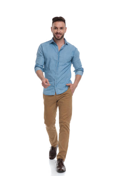 istock man walking with hand in pocket and other one raised 1178038758