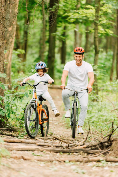 istock full length view od father and son riding above fallen brunches 1178038766