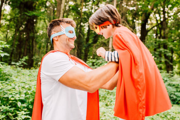 istock side view of father laughing and holding son in hands 1178039358