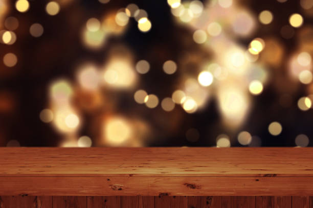istock 3D Christmas background with wooden table against defocussed bokeh lights 1178039491