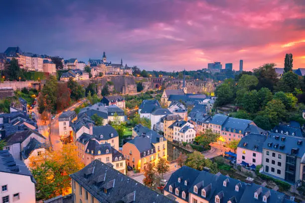 Aerial cityscape image of old town Luxembourg City skyline during beautiful sunrise.