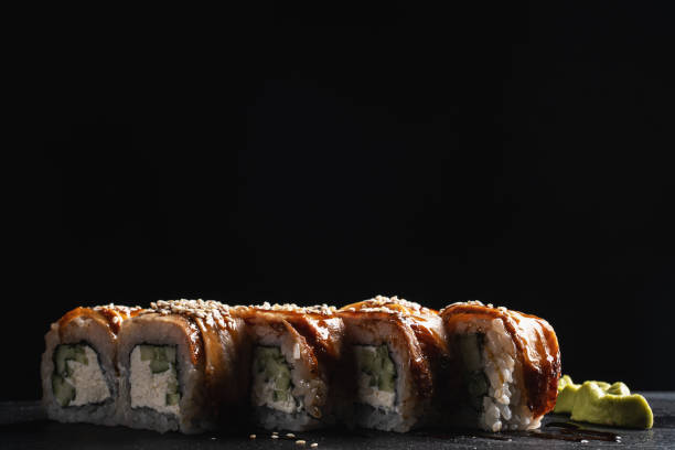 istock Sushi set nigiri and sushi rolls on black stone plate 1178040525