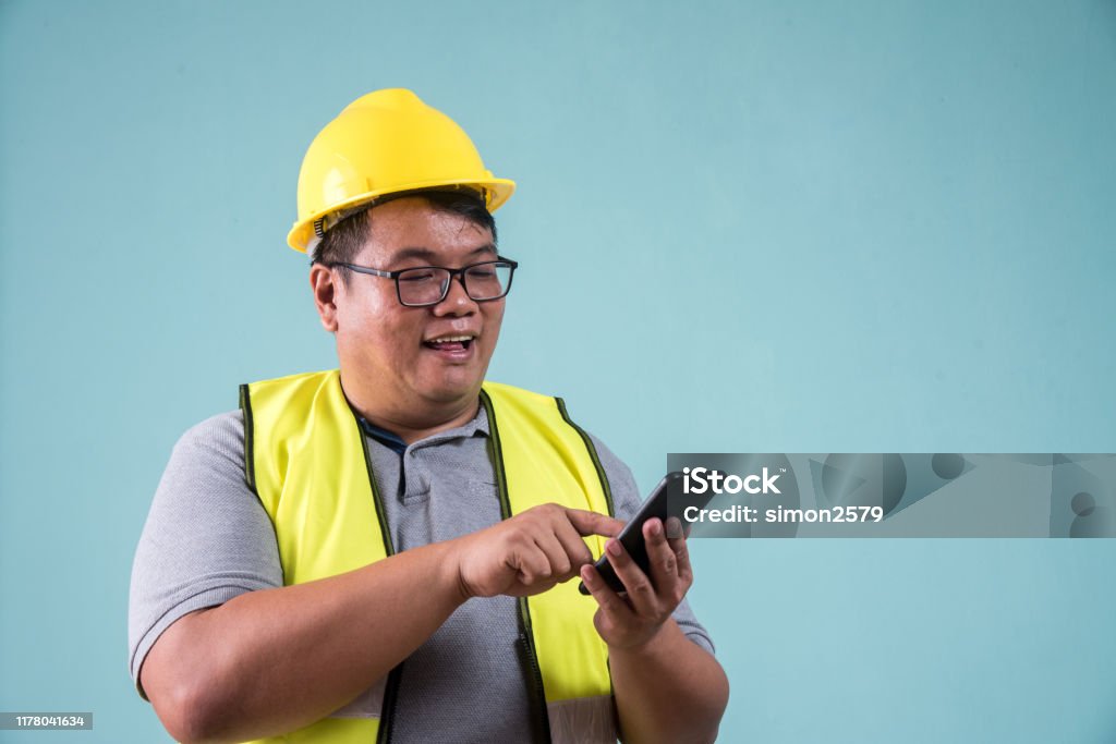 Worker Using Smartphone Construction Worker Using Smartphone With Green Color Background Stock ...