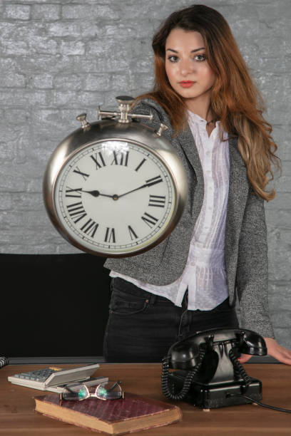 istock business woman shows a big clock 1178041843