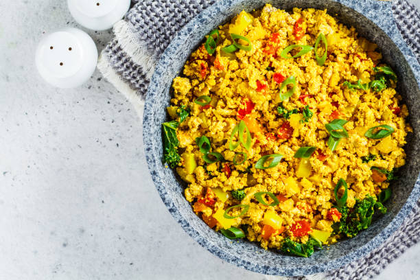 Tofu scramble with vegetables in a pan. Vegan Alternative Omelet. Scramble tofu with vegetables in a pan. Vegan Alternative Omelet. tofu photos stock pictures, royalty-free photos & images