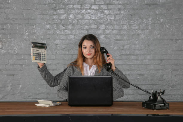 istock Young multitasking business woman sitting at desk 1178043433