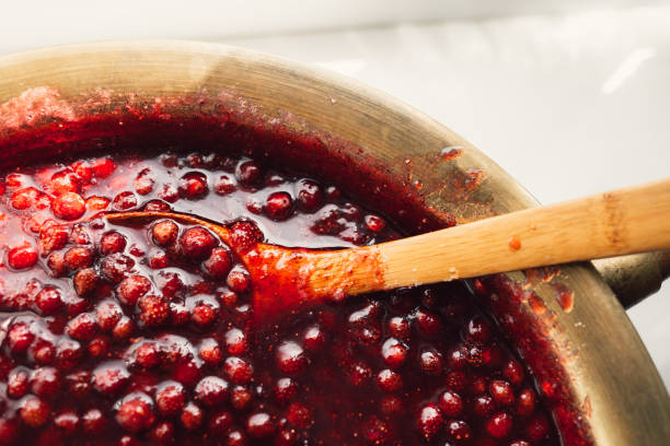 istock spoon immersed in a bowl with strawberry jam 1178044662