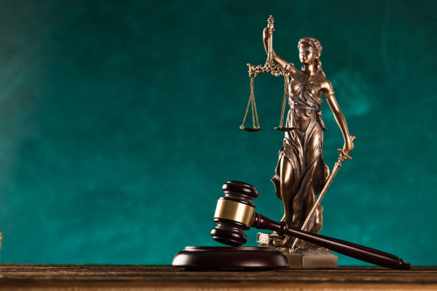 istock brown gavel with statue of justice. 1178046053