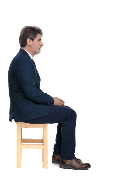 istock businessman sitting and looking ahead while holding hands serious 1178046078