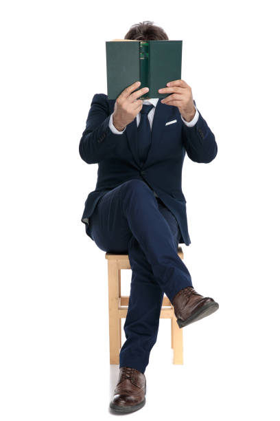 istock businessman sitting with face covered by a book 1178046155