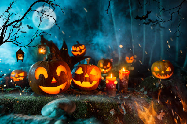 istock Halloween pumpkins on dark spooky forest. 1178046180