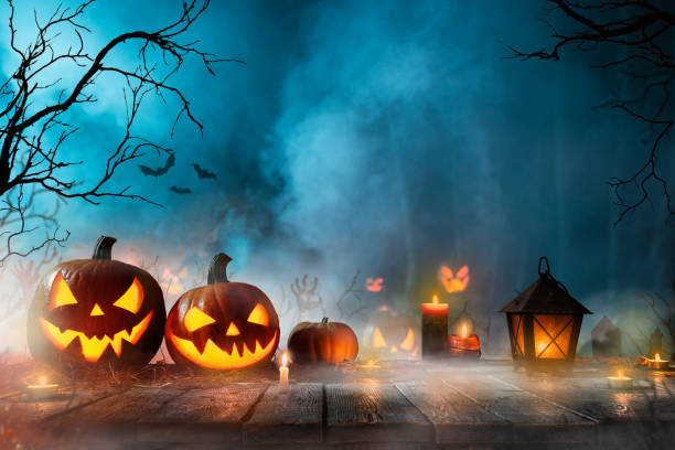 istock Halloween pumpkins on dark spooky forest. 1178046205