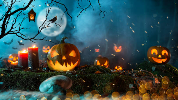 istock Halloween pumpkins on dark spooky forest. 1178046220