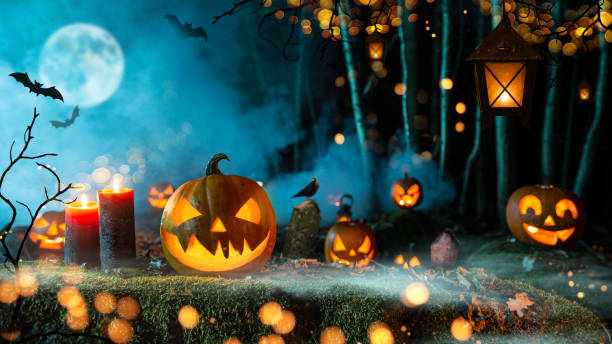 istock Halloween pumpkins on dark spooky forest. 1178046225