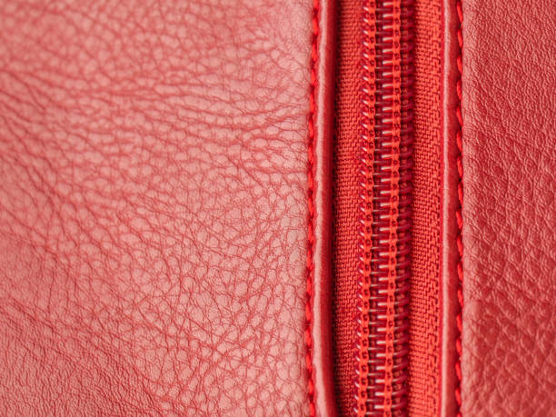 istock Red leather texture with zipper on the right, closeup, copy space 1178048024