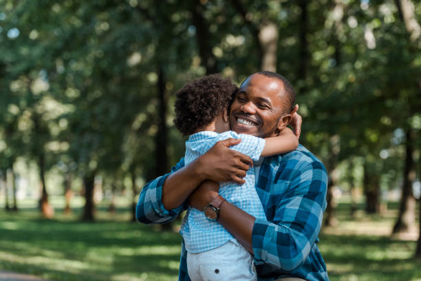 istock happy african american father with closed eyes hugging curly son 1178048211