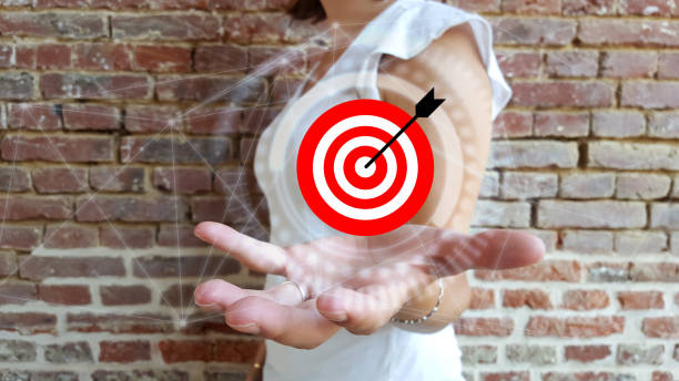 istock Businesswoman holding target and arrow over digital interface 1178048928