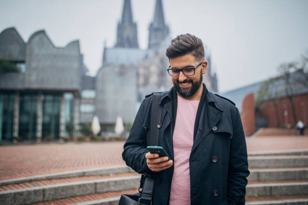 istock Young gentleman using phone on the street 1178049263