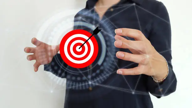 Photo of Businesswoman using target and arrow on digital interface