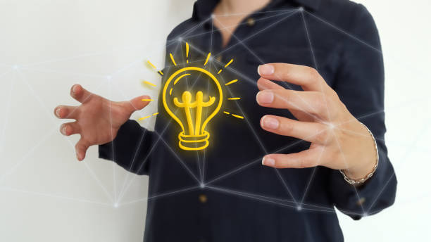 istock Businesswoman using light bulb over connections network 1178049572