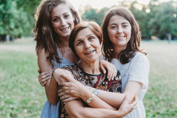 istock Mother and daughters embracing together 1178049747