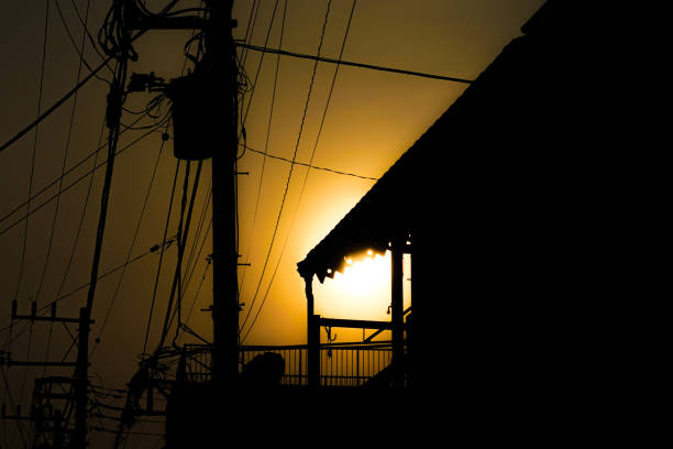 Utility poles and house silhouette. Shooting Location: Tokyo metropolitan area