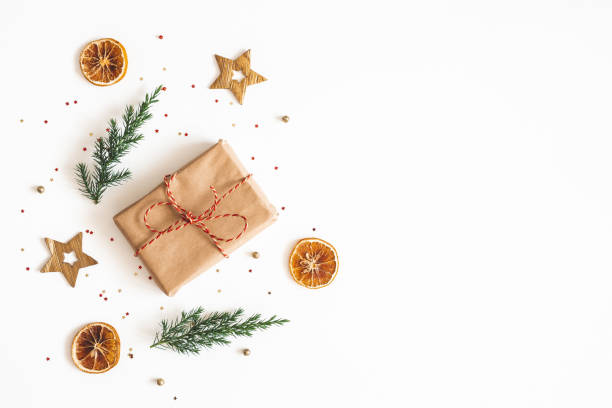 istock Christmas composition. Gift box, fir tree branches, golden decorations on white background. Christmas, winter, new year concept. Flat lay, top view, copy space 1178051590