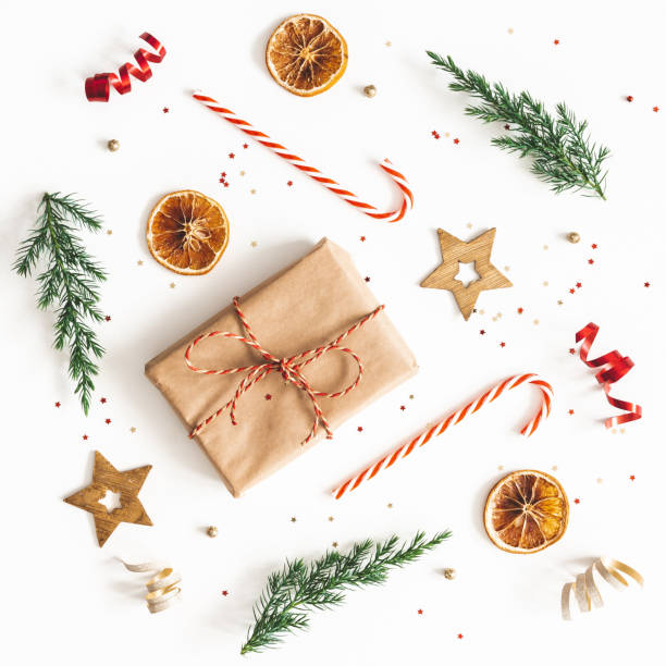 istock Christmas composition. Gift box, fir tree branches, golden decorations on white background. Christmas, winter, new year concept. Flat lay, top view, square 1178051752