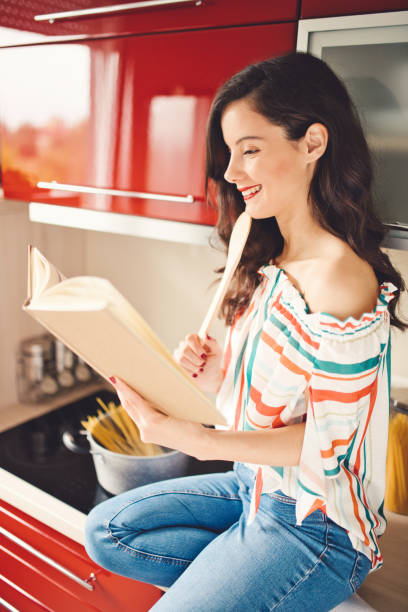 istock Woman reading cookery book 1178052131