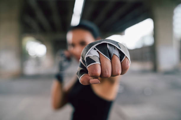 Powerful young woman punching Powerful young woman punching. Thailand, Bangkok extreme dedication stock pictures, royalty-free photos & images