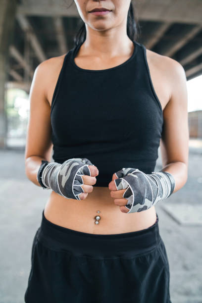 Muay Thai woman fighter with handwraps. Thailand, Bangkok