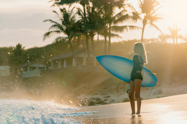 istock Adaptive surfer holding her surfboard and looking out towards the ocean 1178053914