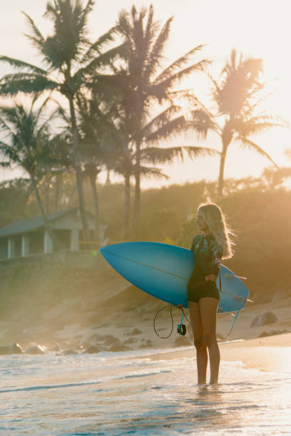 istock Adaptive surfer holding her surfboard and looking out towards the ocean 1178053943
