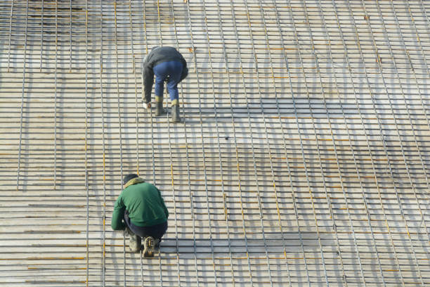 istock Workers bind the reinforcing bars, forming a grid in Foundation of the building.. 1178054062