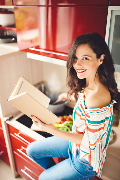 istock Woman holding cookery book 1178055438