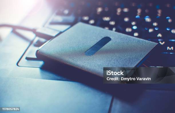 Portable Ssd State Solid Drives Disk On A Laptop Keypad Close Up Stock Photo - Download Image Now