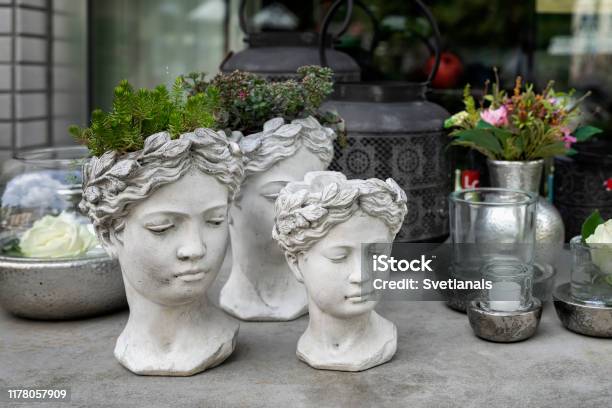 Gypsum Flower Pot In The Shape Of Antic Head Of Goddess With Growning Out Green Flowers Stylish Home Decor Stock Photo - Download Image Now