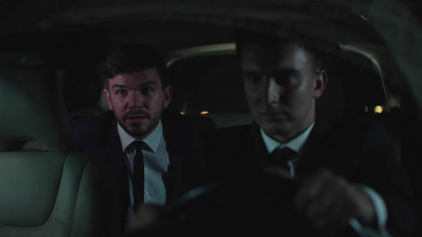 istock Man drive in car in the backseat at night 1178059202
