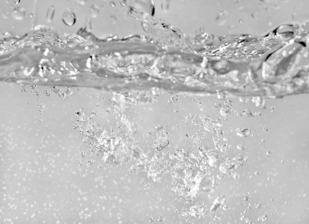 istock Water splashes as liquid is poured into the tank, abstract background 1178059628