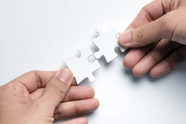 istock Partnership concept with hands putting puzzle pieces together 1178060814