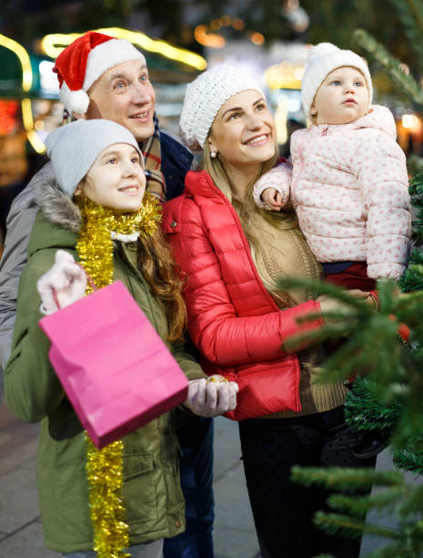 istock Parents with daughters choosing Christmas tree 1178061566