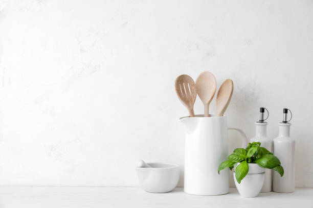 Contemporary kitchen background with blank space for a text Contemporary kitchen background with kitchen utensils standing on white countertop, blank space for a text, front view kitchen utensil photos stock pictures, royalty-free photos & images