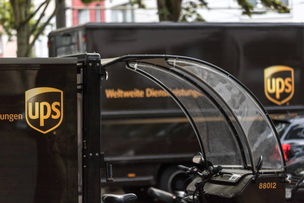ups cargo bicycle and cargo truck in cologne germany stock photo